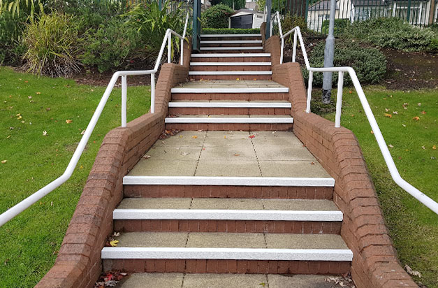 Completed, with white DDA compliant nosings applied to concrete slab steps. Completed, with white DDA compliant nosings applied to concrete slab steps.
